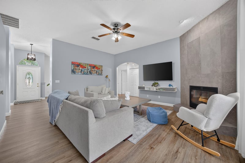 Living room with fireplace and rocking chair at 8921 Needlepoint Pl, Jacksonville, FL 32244