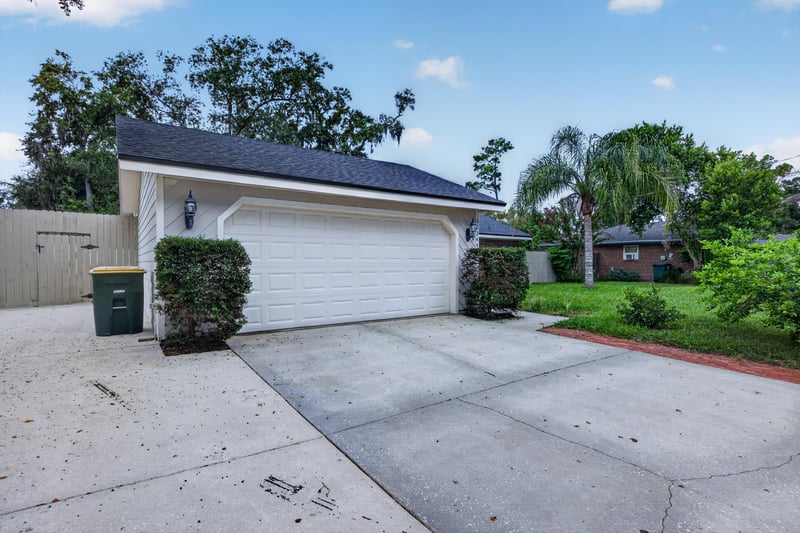 Front exterior with two-car garage and driveway at 12344 Cormorant Ct, Jacksonville, FL