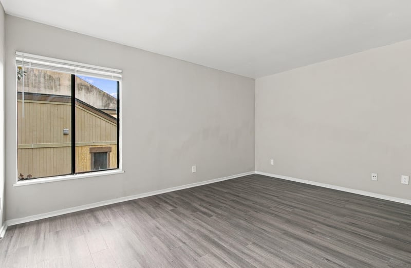 Bedroom with window and wood-look floor at 7703 Las Palmas Way