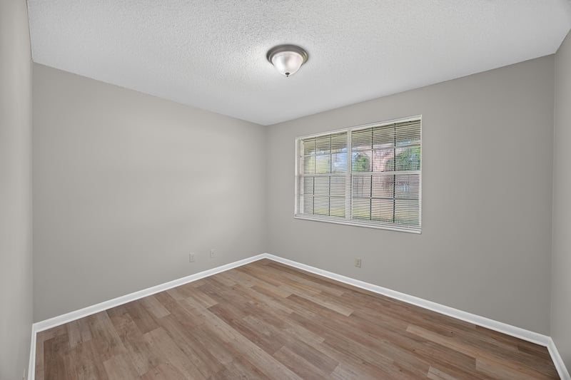 Bedroom with window and wood-look flooring at 12351 Condor Dr