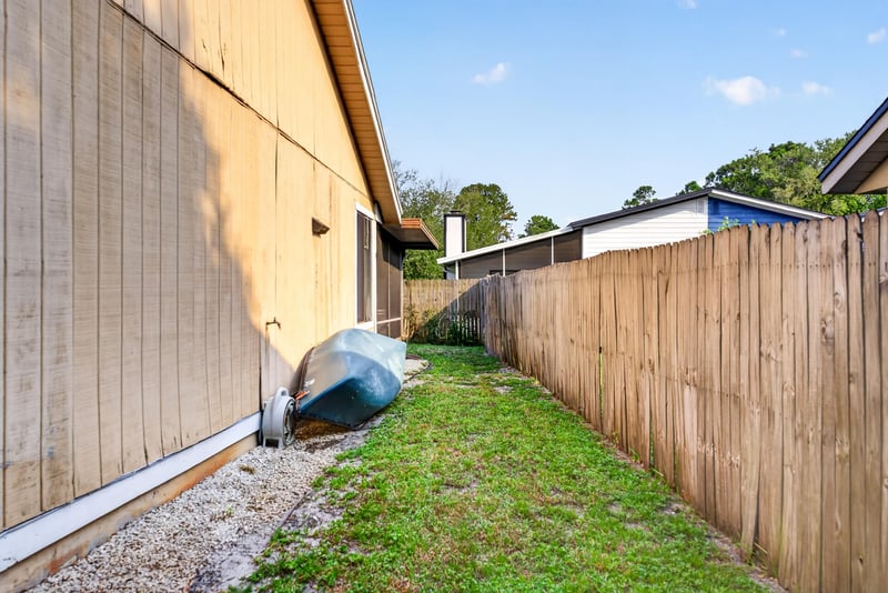 Side yard with wood fence at 13020 Medford Ln, Jacksonville, FL 32225