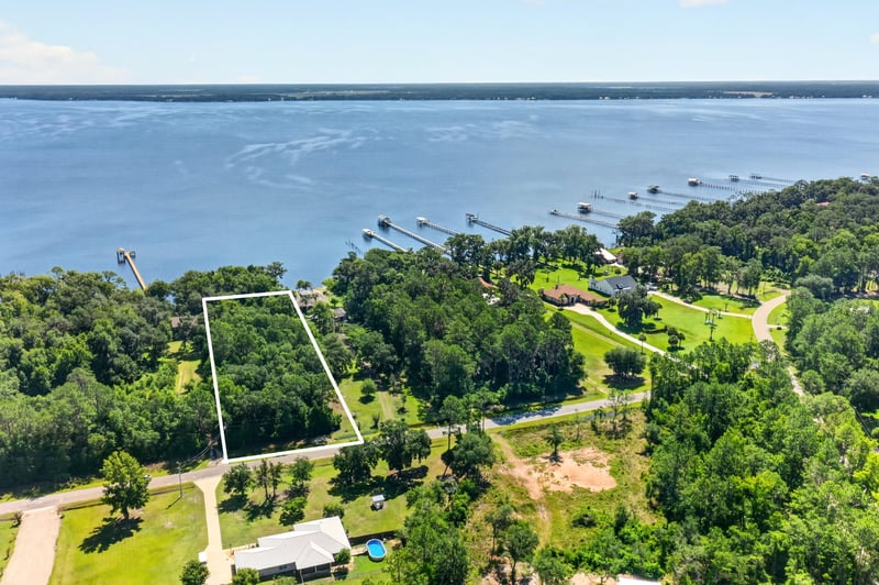 Aerial river view with the parcel outlined in white at 110 River Shores Rd, Palatka, FL 32043