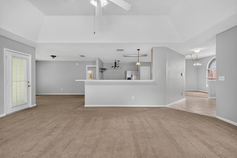 Kitchen bar opening to the living room at 11669 Collins Creek Dr, Jacksonville, FL 32258