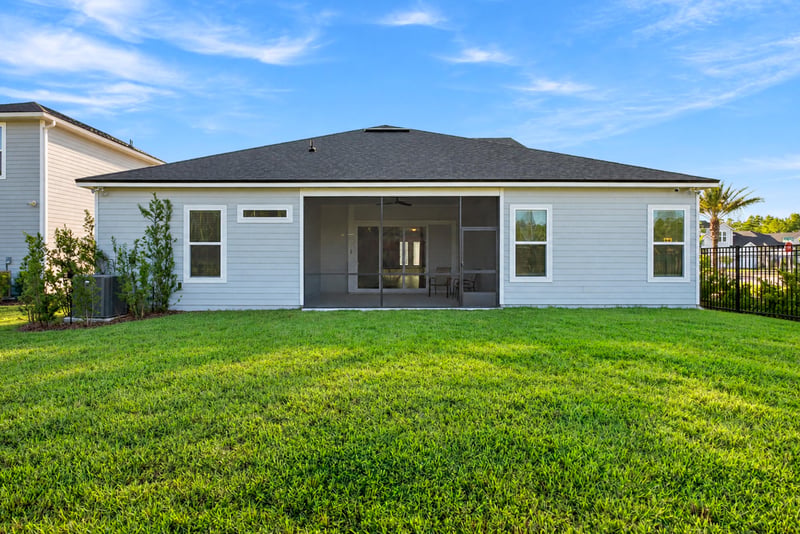 Rear exterior in daylight with screened lanai and lawn at 27 Holly Rdg Wy, St. Augustine, FL