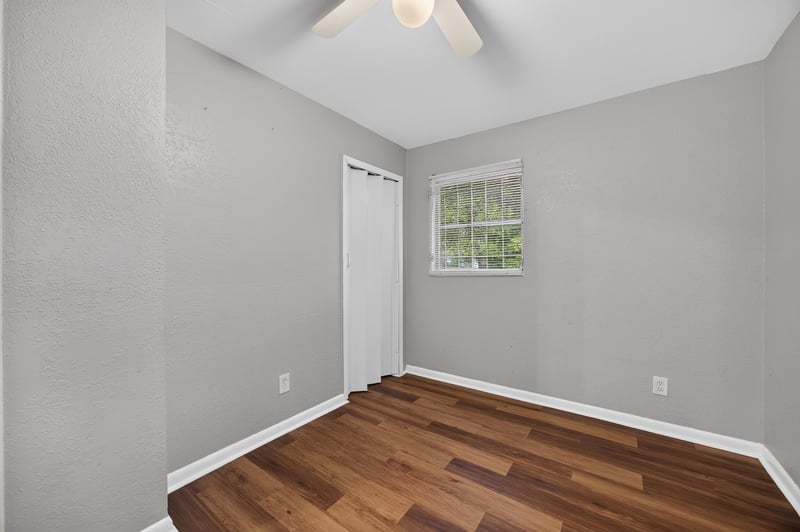 Empty room with window and wood-look floor at 4030 Leonard Cir W, Jacksonville, FL 32209