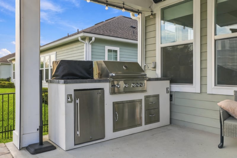 Outdoor kitchen with built-in grill at 3921 Spyglass Hill Ln