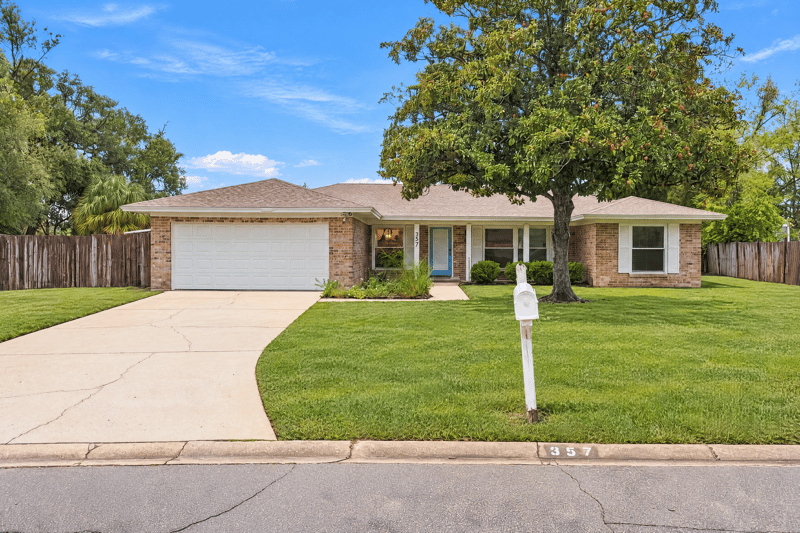 Front exterior with two-car garage and driveway at 357 Dillon Dr, Orange Park, FL