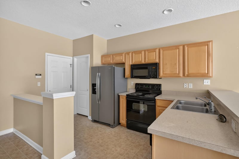 Kitchen with black appliances and countertop at 12359 Mangrove Forest Ct, Jacksonville, FL 32218