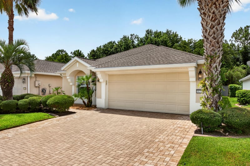 Front exterior with two-car garage and driveway at 11225 Water Spring Cir, Jacksonville, FL 32256