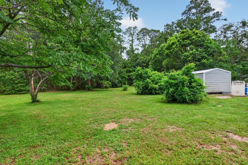 Yard view with shed and surrounding trees at 3249 Maryland Ave, Green Cove Springs, FL