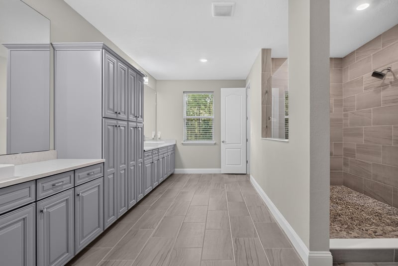 Primary bathroom with linen cabinets at 22 Azura Point