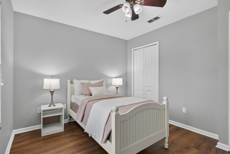 Bedroom with staged bed at 706 Grampian Highlands Dr, St. Johns, FL 32259