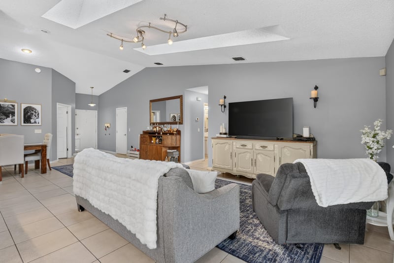 Living room with sofa and TV stand at 13020 Medford Ln, Jacksonville, FL 32225