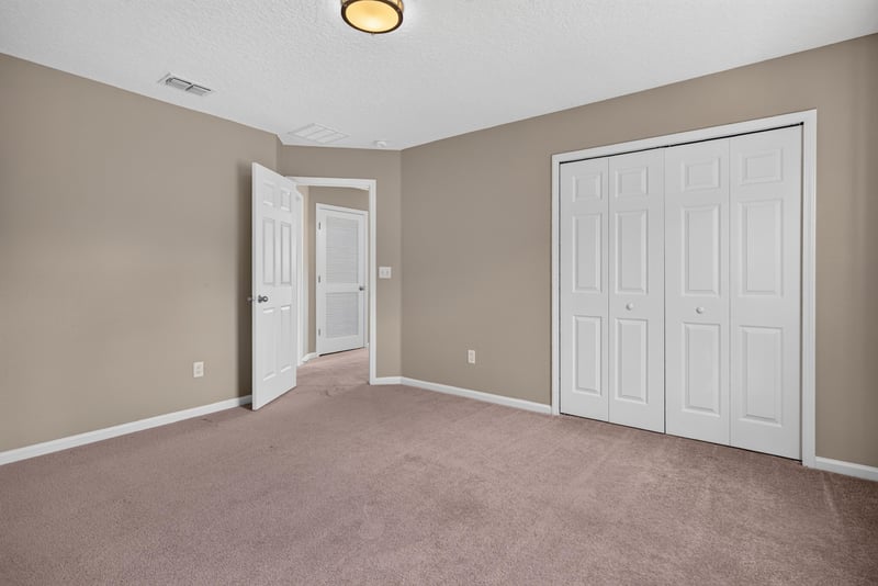 Bedroom with carpet and closet doors at 13685 Goodson Pl, Jacksonville, FL 32226