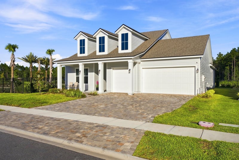 Front exterior from street with paver driveway and dormer windows at 27 Holly Rdg Wy, St. Augustine, FL