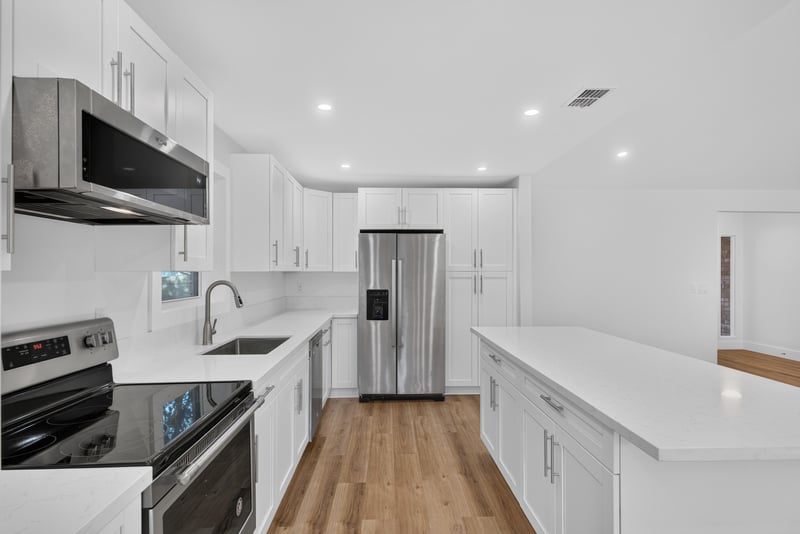 Kitchen stove and white cabinetry at 8453 Boysenberry Ln W, Jacksonville, FL