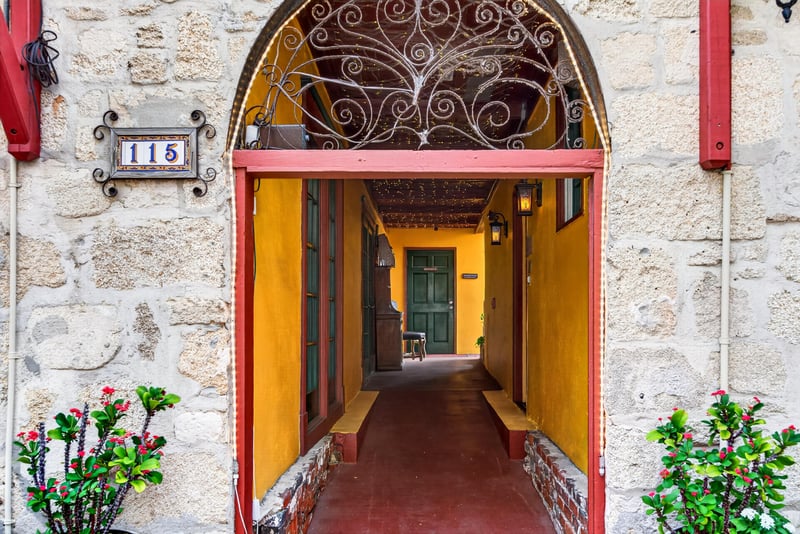 Interior entry corridor with house numbers and potted plants at 115 Cordova St, St. Augustine, FL