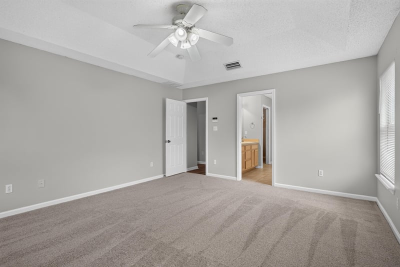Bedroom with carpet opening to hallway at 12949 Chets Creek Dr S, Jacksonville, FL 32224