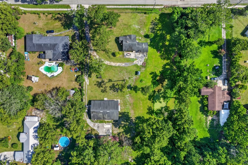 Aerial view of the property with a pool visible in the distance at 5745 110th St, Jacksonville, FL 32244