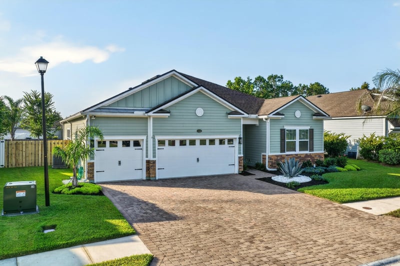 Aerial front view showing driveway and street at 3328 Southern Oaks Dr, Green Cove Springs, FL 32043