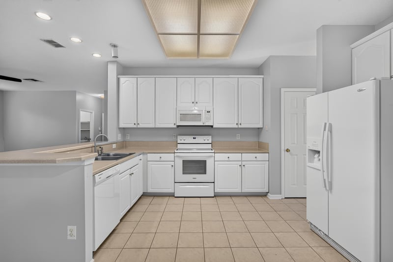 Kitchen with white cabinets and tile floor at 470 Sparrow Branch Cir, Jacksonville, FL 32259