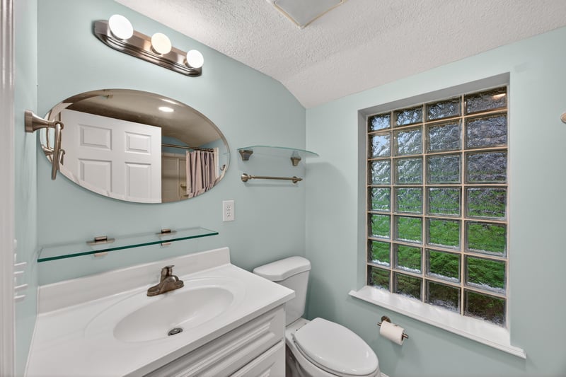Bathroom with pedestal-style sink and window at 1619 Hammond Blvd, Jacksonville, FL