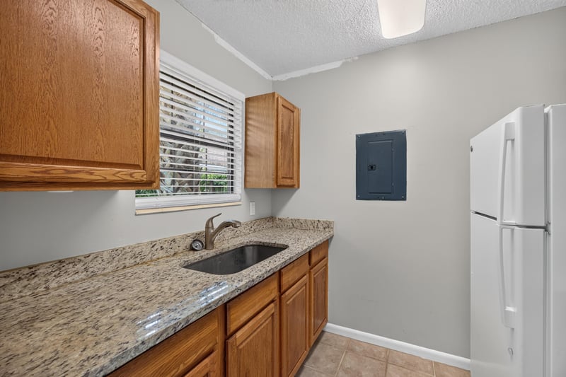 Kitchen sink area with granite counter at 2719 Trollie Ln
