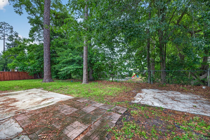 Backyard patio area surrounded by trees at 1083 Stokes St, Jacksonville, FL
