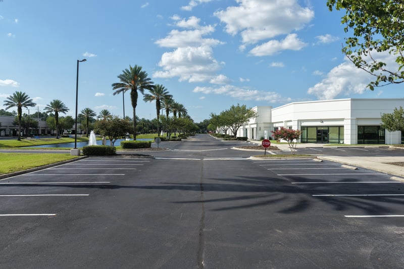 Palm-lined parking area with shadowed pavement at 10550 Deerwood Park Blvd, Jacksonville, FL 32256