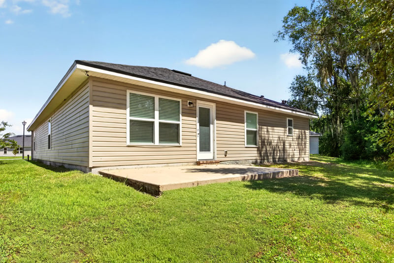 Rear exterior with siding and window at 9846 Olivia St, Jacksonville, FL