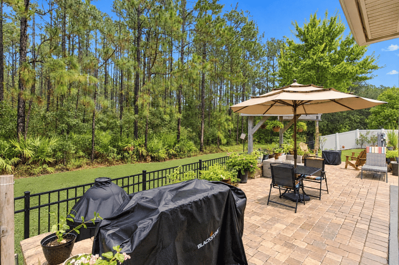 Backyard patio with grill and seating at 10923 Black Diamond Ct, Jacksonville, FL