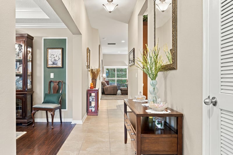 Entry hallway with tile floor and console table at 10923 Black Diamond Ct, Jacksonville, FL