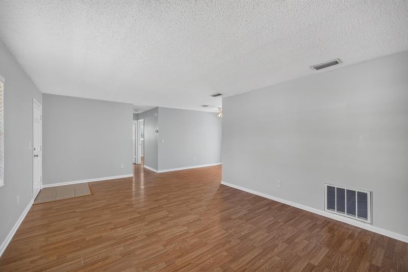 Living and dining area with wood laminate flooring at 328 Palos Ct, St. Augustine, FL