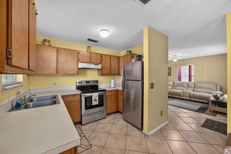 Kitchen sink area with tile backsplash at 5375 Dodge Rd, Jacksonville, FL 32209