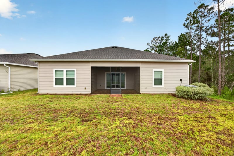 Rear exterior with covered lanai at 9905 Ansley Lake Dr, Jacksonville, FL