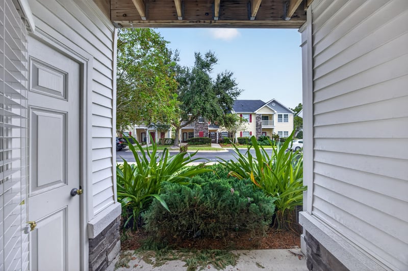 Covered porch doorway with view to the courtyard at 575 Oakleaf Plantation Pkwy, Orange Park, FL 32065