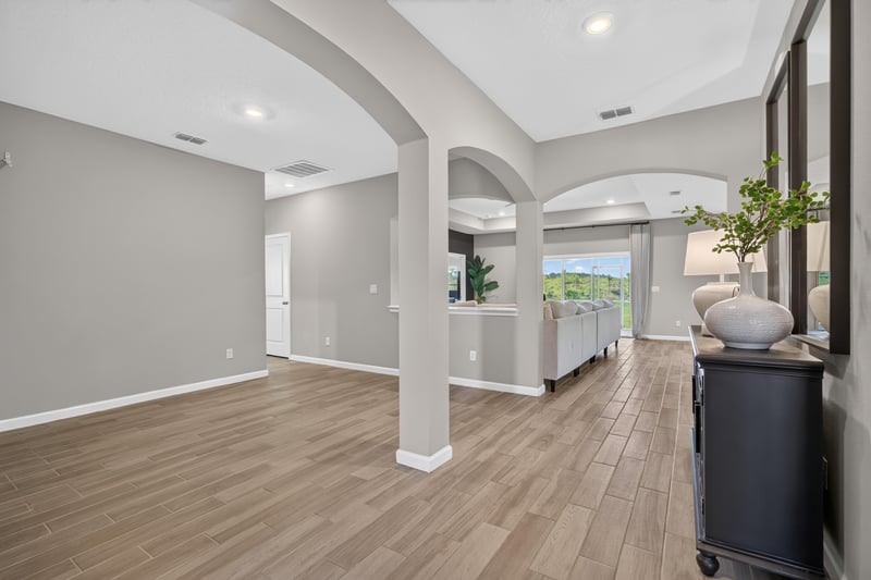 Foyer with columns and wood-look flooring at 9942 Lovage Ln, Jacksonville, FL 32219
