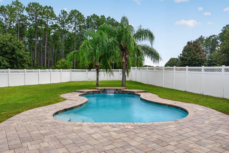 Backyard pool and white vinyl fence at 706 Grampian Highlands Dr, St. Johns, FL 32259