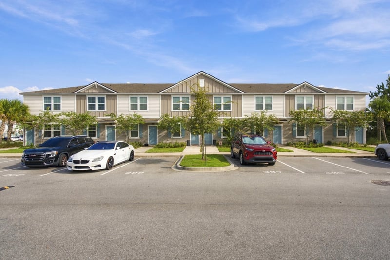 Front exterior of two-story townhome with attached parking at 8359 Zenith Cir, Jacksonville, FL 32256