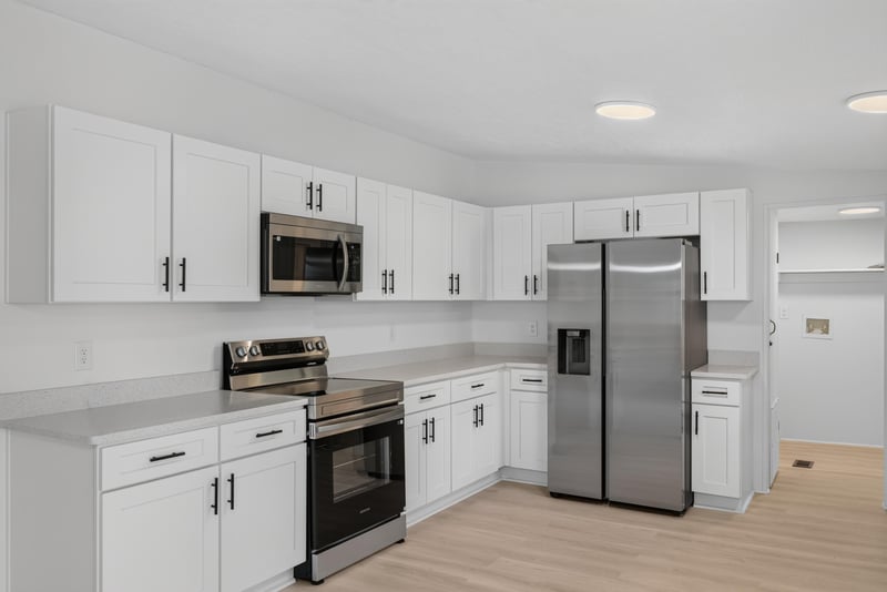 Kitchen with island and stainless refrigerator at 55520 Jewel-Thomas Rd, Callahan, FL 32011