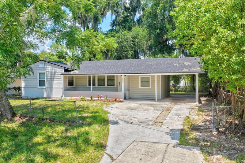 Front exterior showing driveway and carport at 855 Cornwallis Dr, Jacksonville, FL