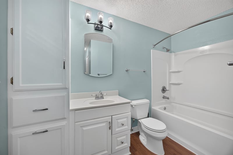 Bathroom with white vanity and tub-shower combo at 892 Branscomb Rd, Green Cove Springs, FL