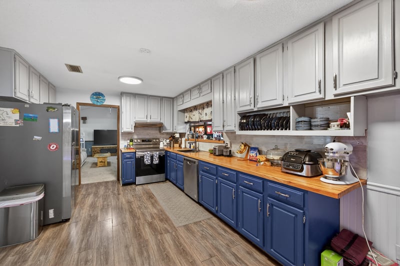 Kitchen with wood counters and open shelving at 981 Marble Ridge Dr, Orange Park, FL 32065
