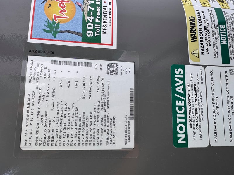 Condenser nameplate with hazard notice and service sticker at 11700 New Kings Rd, Jacksonville, FL 32219