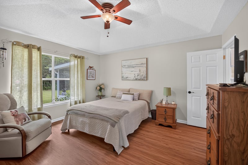Primary bedroom with windows and seating area at 13514 Las Brisas Way N, Jacksonville, FL