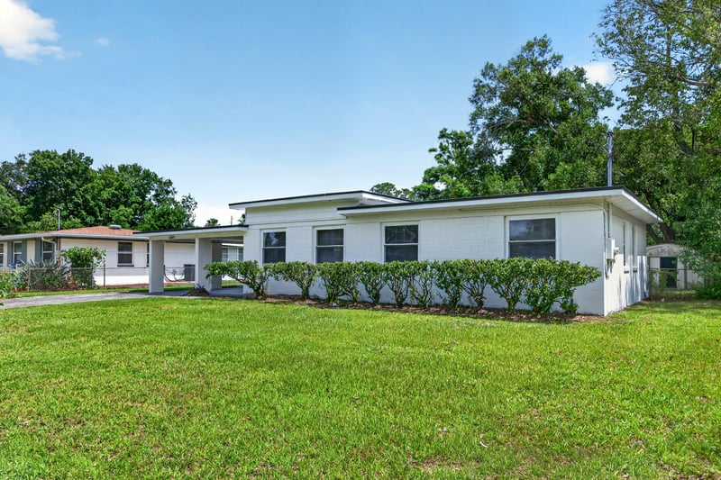 Front exterior view with driveway and landscaped yard at 6238 Randia Dr, Jacksonville, FL 32210