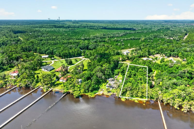 Aerial view of the lot boundary along the river with docks at 110 River Shores Rd, Palatka, FL 32043
