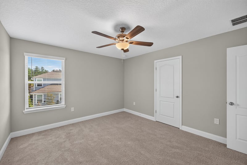 Primary bedroom with two closet doors at 331 Millerstone Dr, St. Augustine, FL 32092