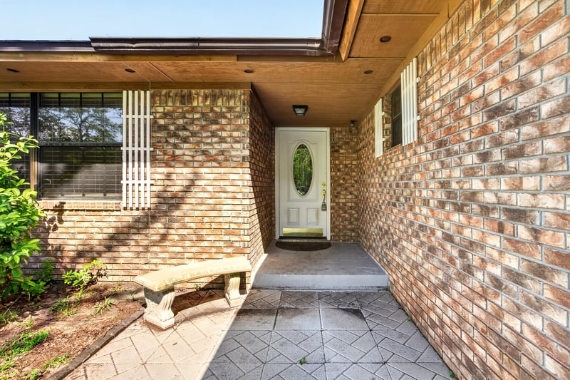 Covered brick entry walkway leading to the front door at 2435 Range Line Rd, Middleburg, FL