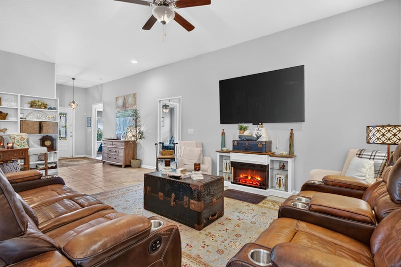 Living room with fireplace and trunk coffee table at 589 Seville Pkwy, St. Augustine, FL